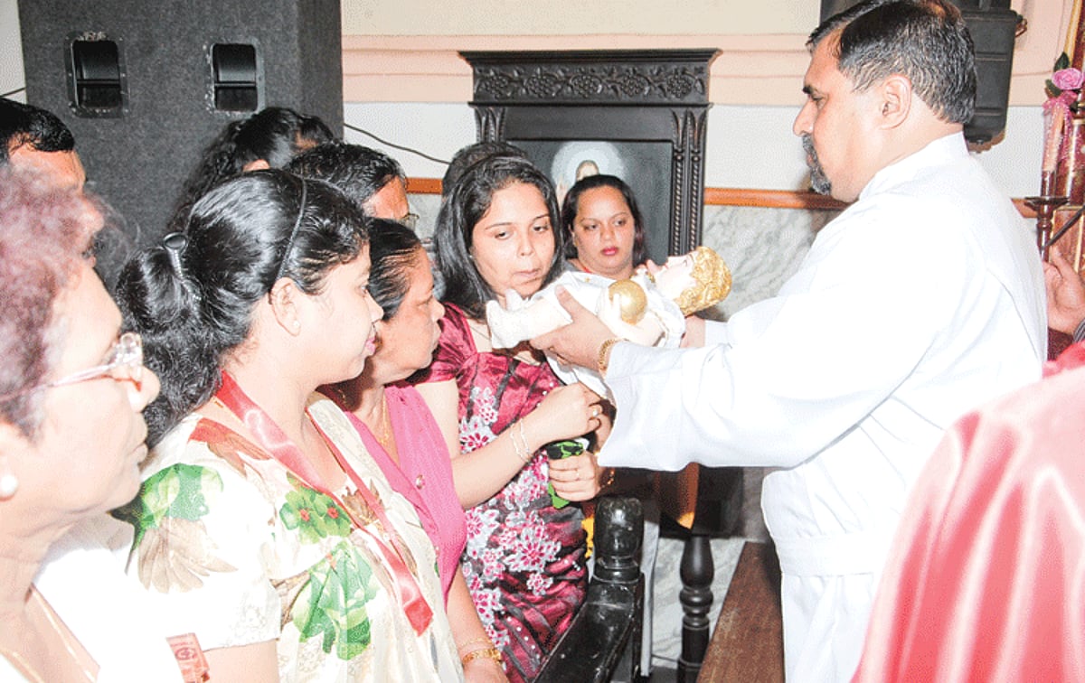 Devotees venerate the miraculous statue of Infant Jesus at the Colva Fama on Monday.