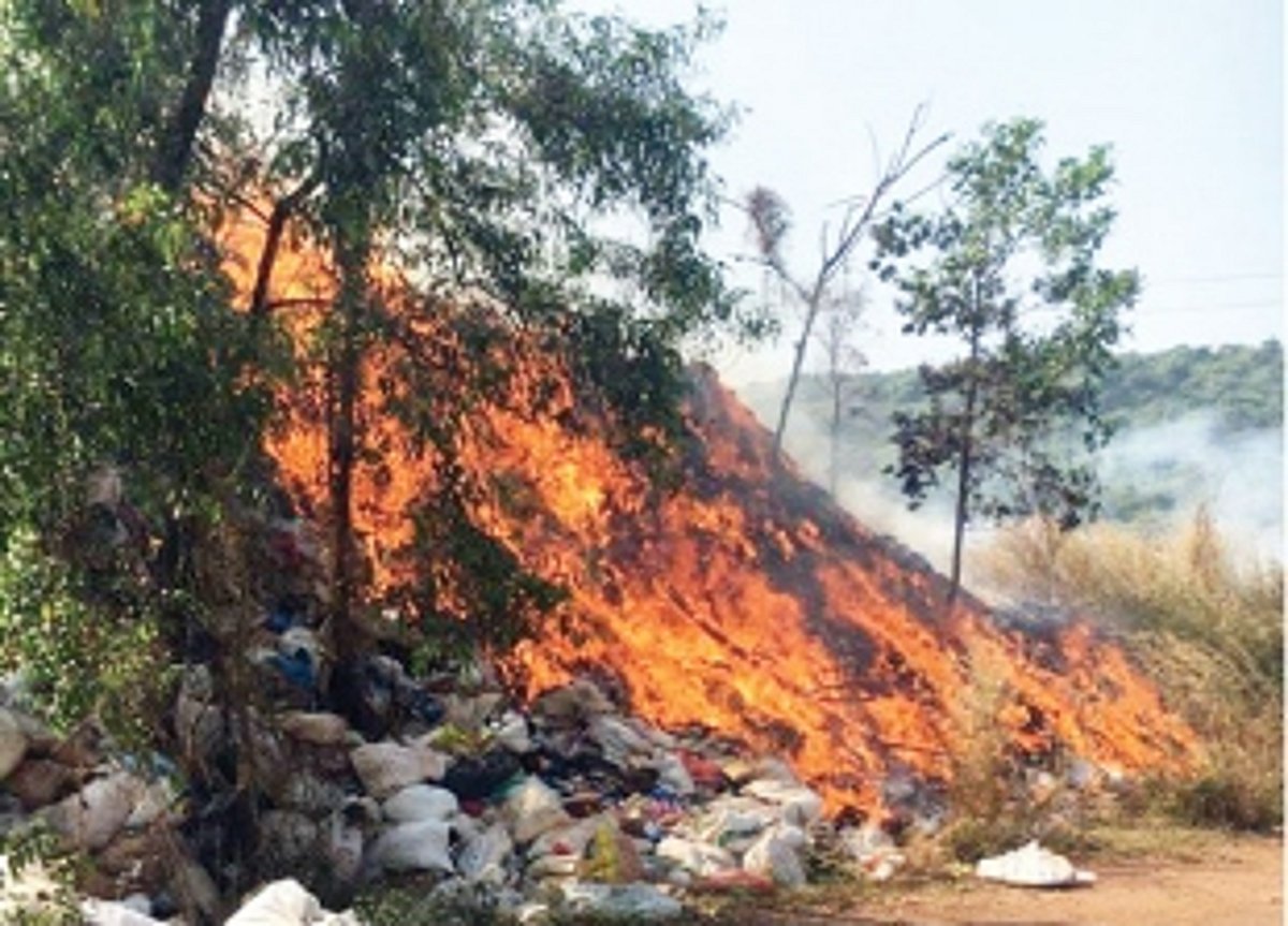 Dry waste piled up beside old dump catches fire