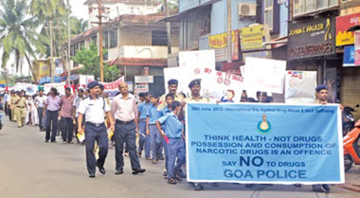 DySP N C Raikar along with police officers and students march through the streets