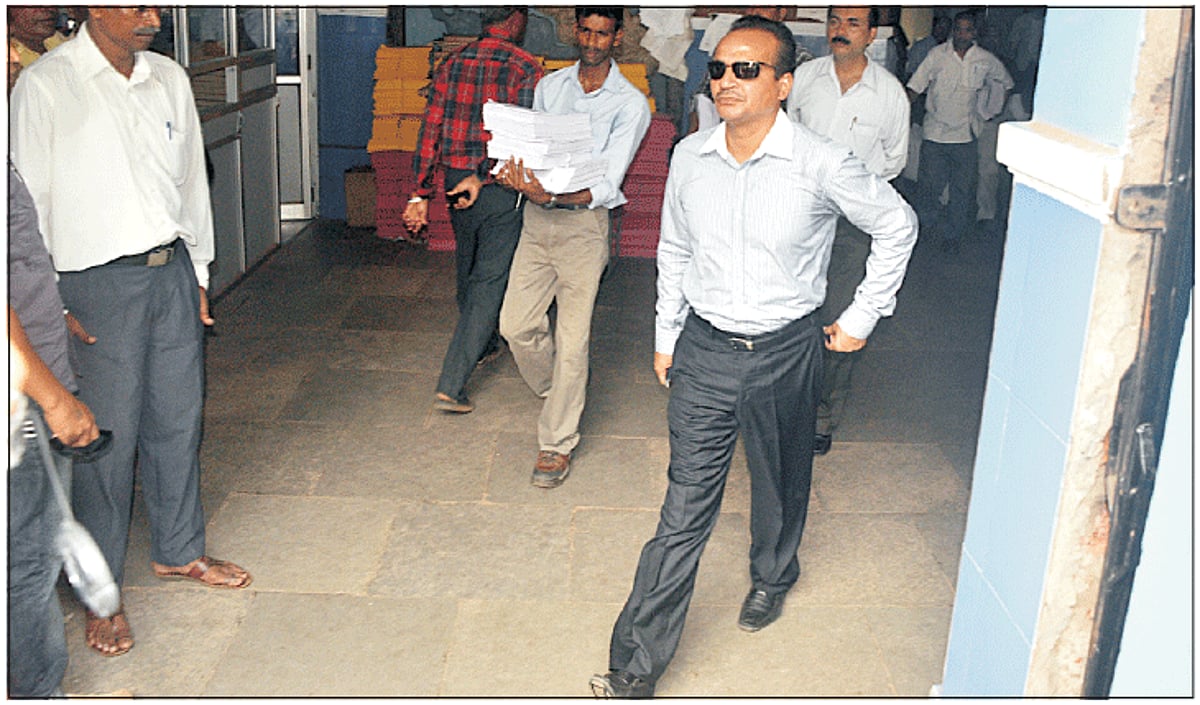 Education Minister Babush Monserrate makes his way out of the District & Session Court Building after appering in JMFC in connection with the attack on Panjim police station.