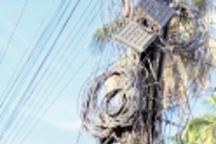 Electric light pole  loaded with cables at Maria Hall crossing.