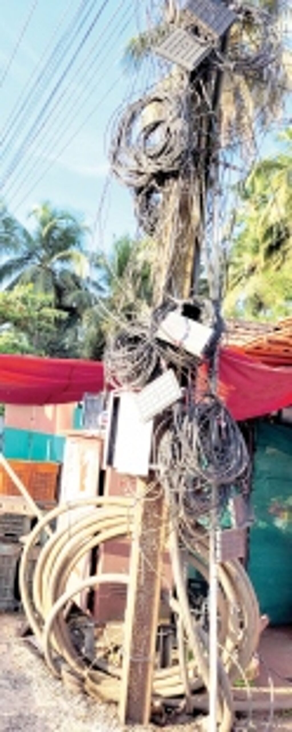 Electric light pole  loaded with cables at Maria Hall crossing.