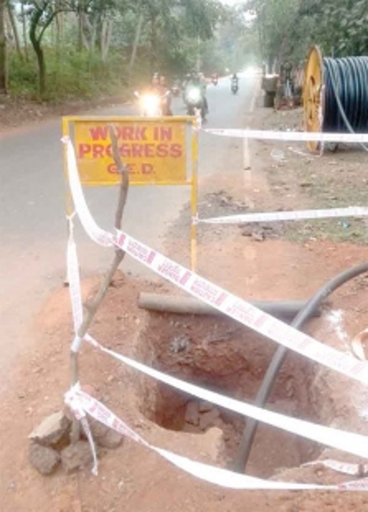 Electricity Dept contractor installs ‘work in progress’ sign near open pit