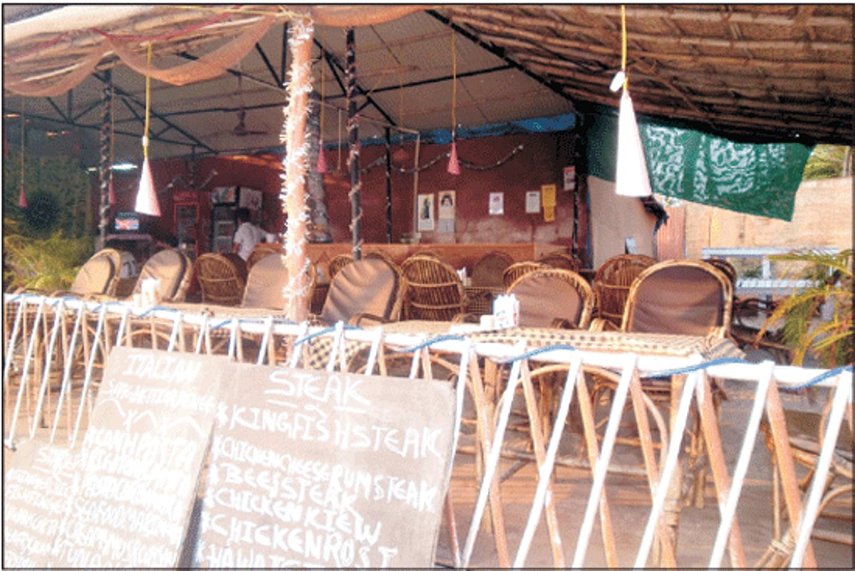 Empty chairs in beach restaurant await customers at Palolem.