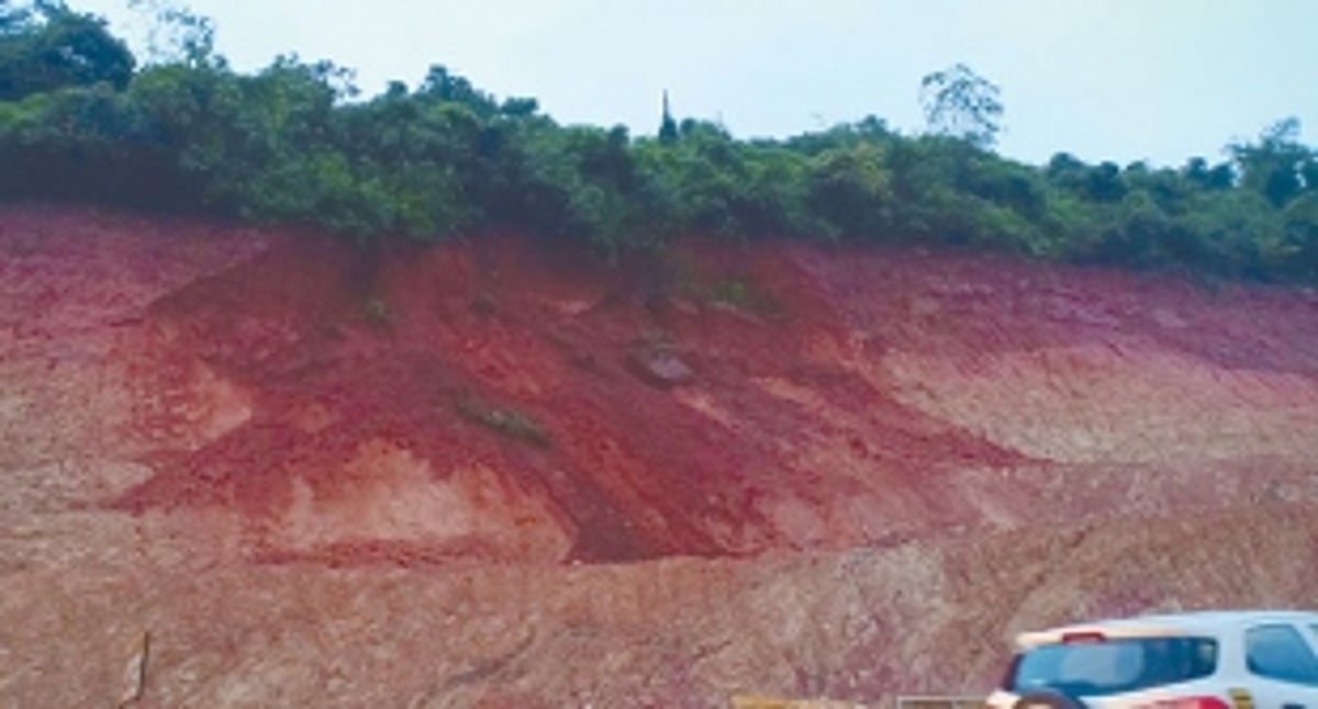 Excavated mud slides down  the hill at Cortalim junction