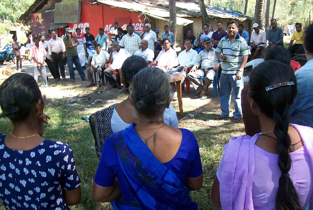 Farmers gather near the Paroda church to protest against government's move to acquire a paddy field.
