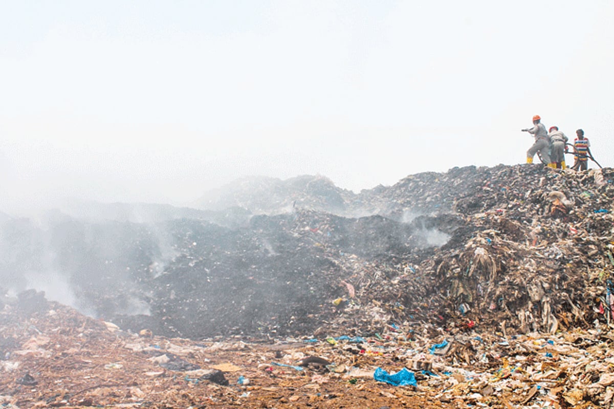 Fire personnel battle to extinguish the fire at the garbage site at Headland Sada, Vasco.