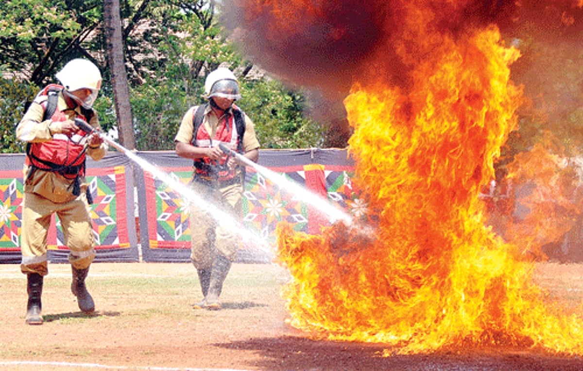 Fire personnel douse flames at a live fire fighting demonstration at the Fire Force headquarters, St Inez.