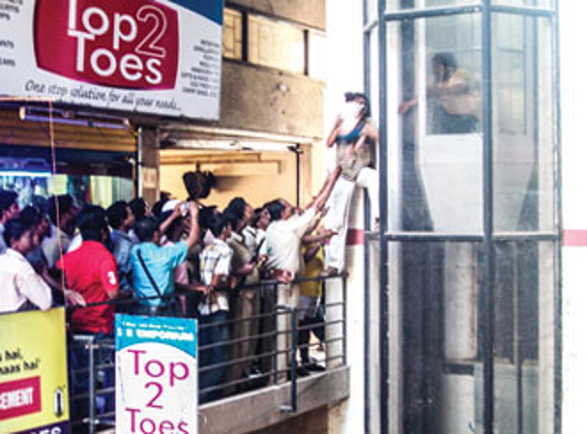 Firefighters rescue a toddler after breaking open the glass of an elevator