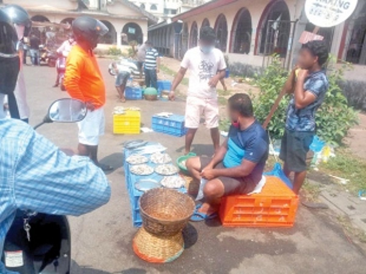 Fish vendors sell fish in the open at SGPDA market