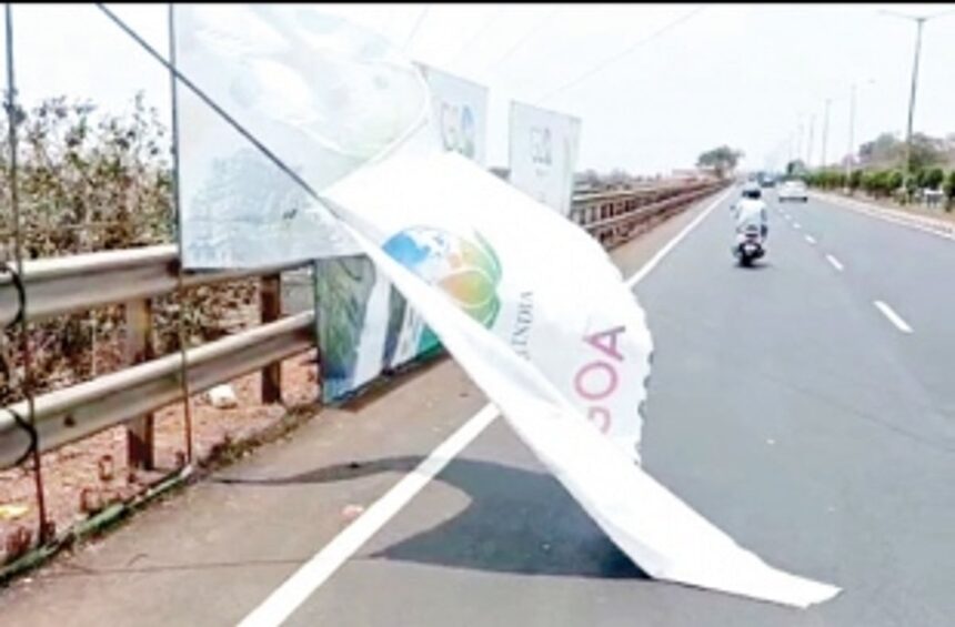 G20 banners put ostensibly to cover a slum area pose danger to motorists