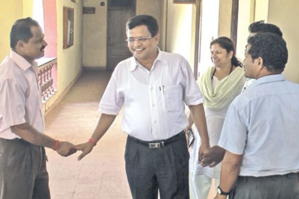 Goa Law Commission Chairman Narendra Sawaikar greets former Sanguem MLA Meng Gaonkar