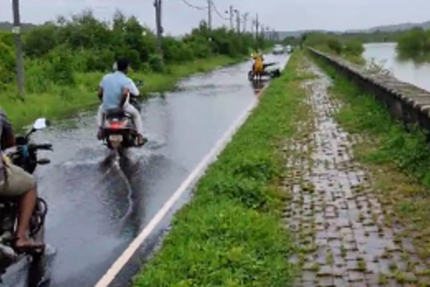 Hazardous road conditions lead to a bike accident as woman falls into submerged pothole in Britona