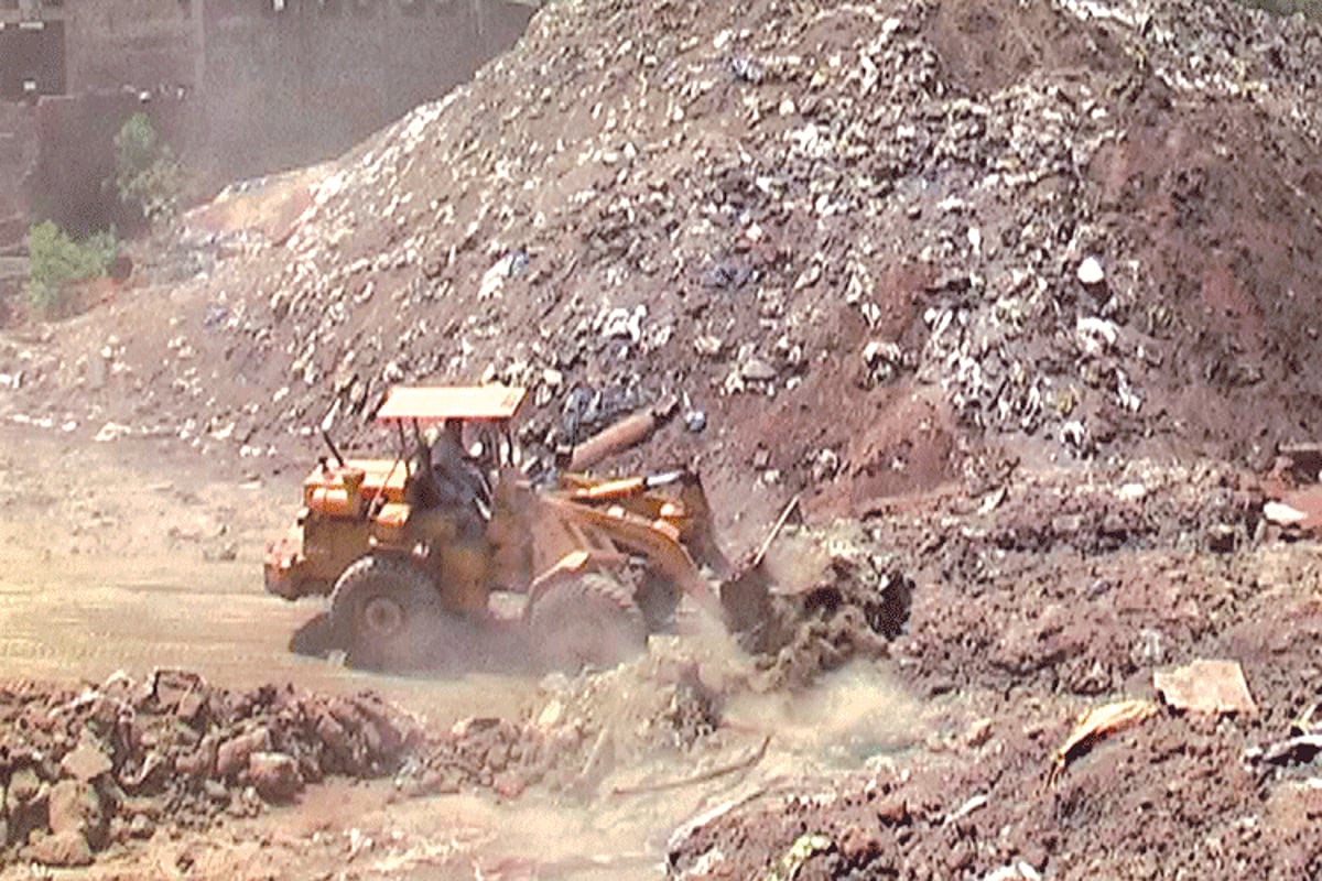 Heavy earthmoving machinery at work at the site of hazardous waste at Cuncolim Industrial estate.