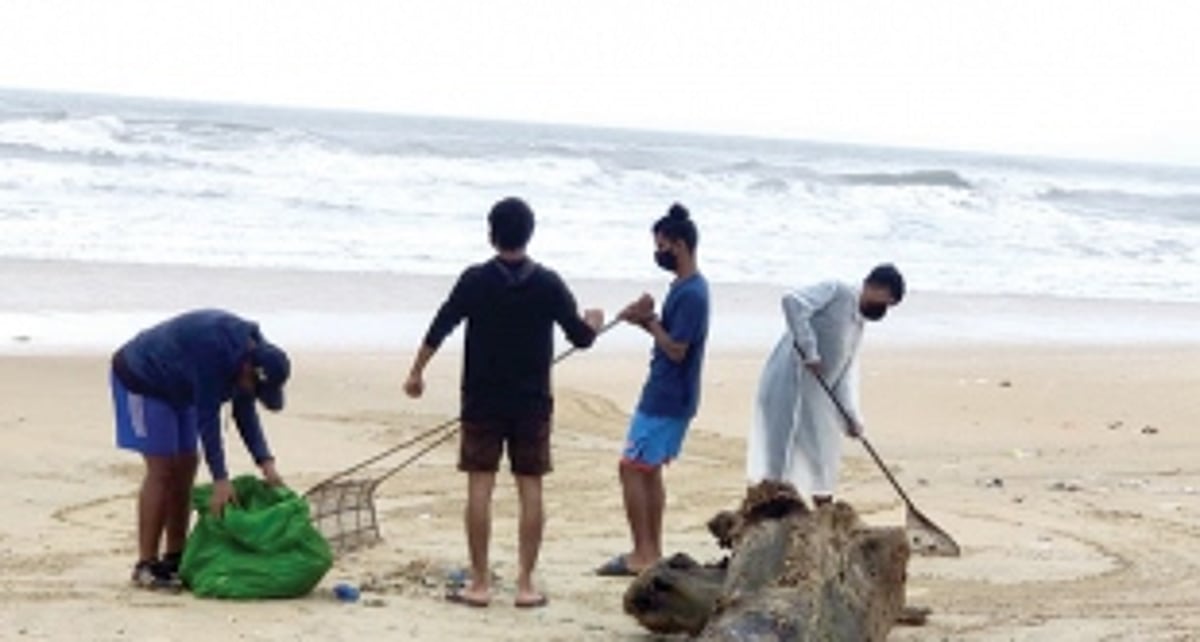 Holy Trinity Church parishioners clean garbage littered on beach