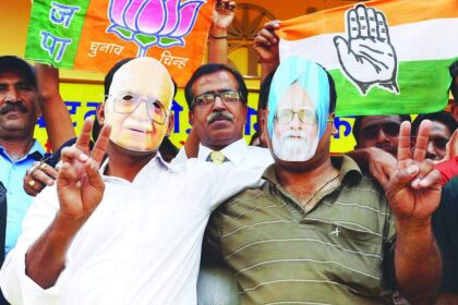 Hotel staff wear masks of Prime Minister Manmohan Singh and opposition Bharatiya Janata Party prime ministerial candidate LK Advani as they urge voters to go to the polls in Amritsar.