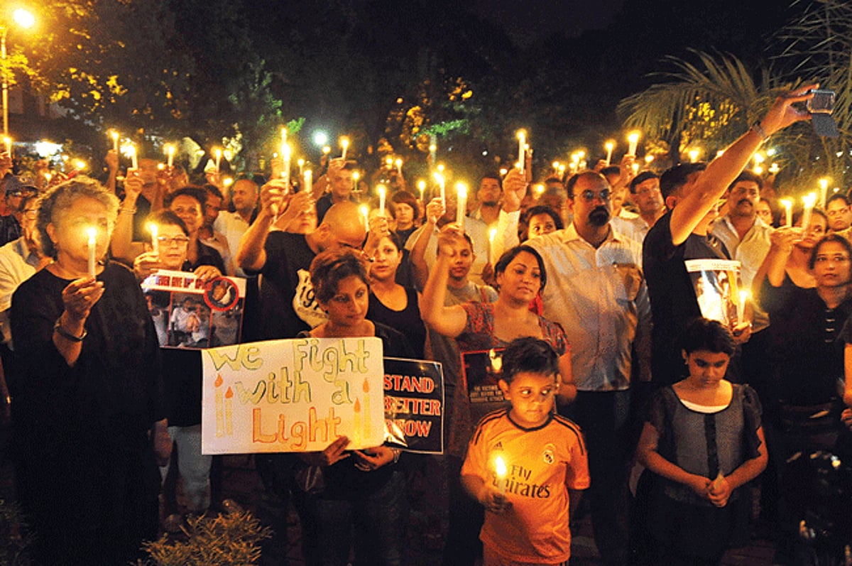 IN UNITY FOR JUSTICE: People take part in the solidarity candlelight vigil, demanding justice for the sword attack victims, at Campal on Saturday.