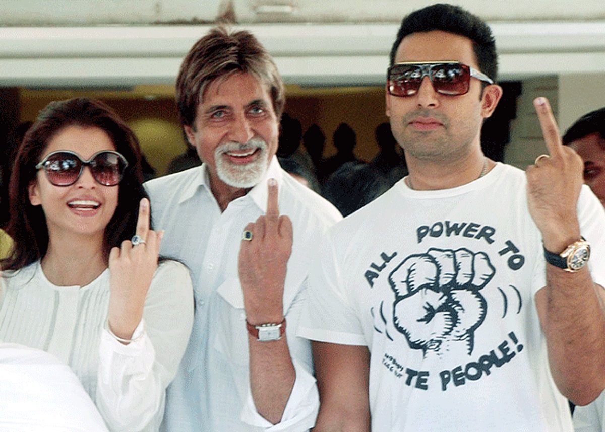 Indian Bollywood film actors Aishwariya Rai Bachchan (L), Amitabh Bachchan (C) and Abhishek Bachchan (R) display their ink-marked fingers after casting their vote at a polling booth in Mumbai