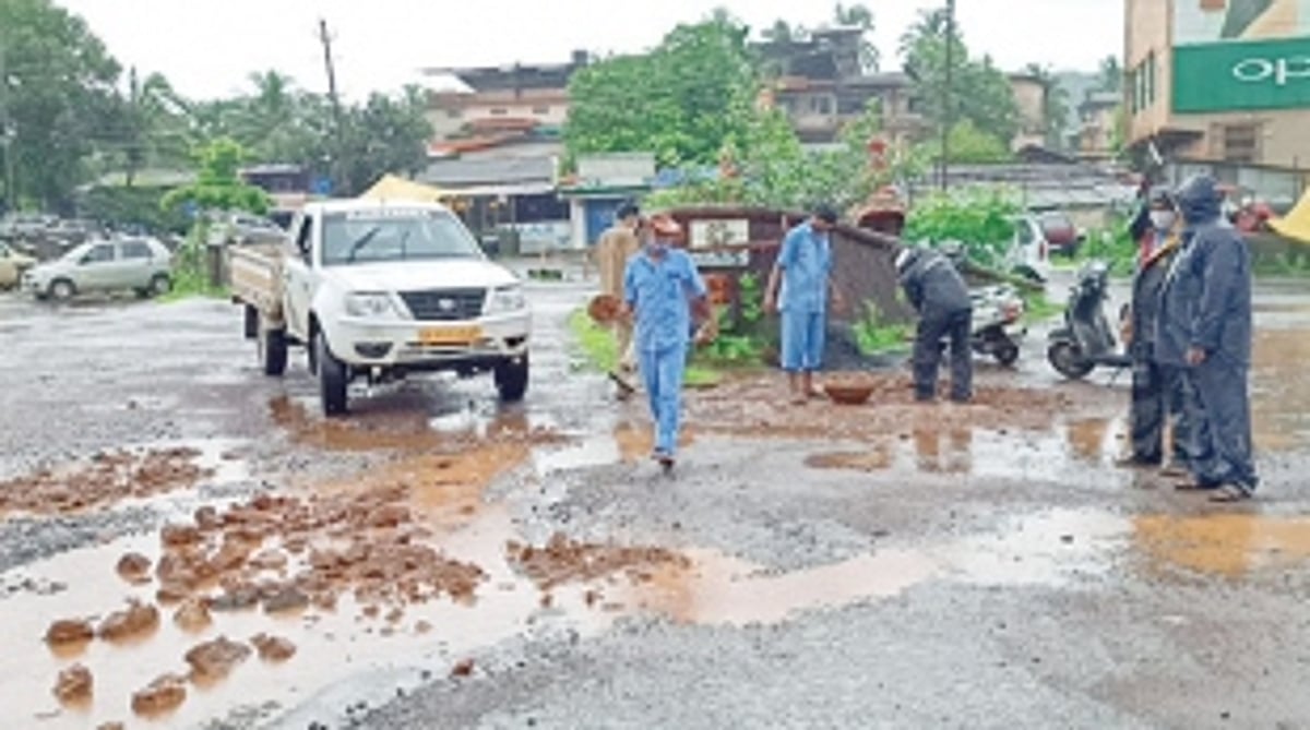 KTC workers fill potholes  at Bicholim bus stand