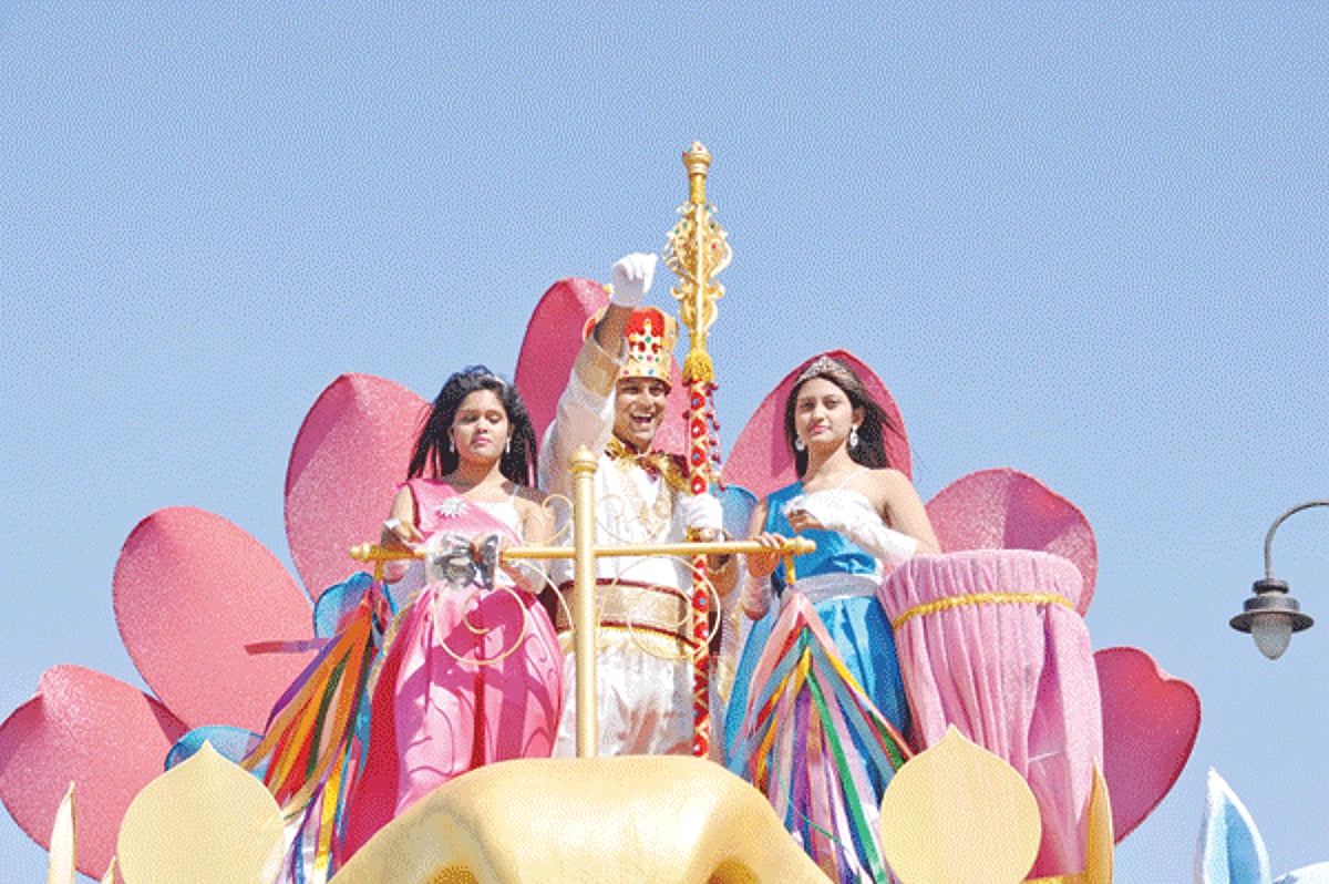 King Momo waves to the crowd as his entourage leads the Panjim float parade through the streets, on Saturday