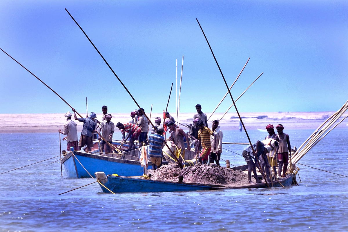 Labourers extract sand from Keri river near Tiracol Fort on Sunday afternoon.