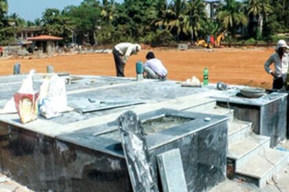 Labourers giving final touches to the stage, which is built outside the new Collectorate building