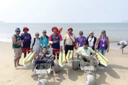 Lifeguards assist differntly-abled persons  to enjoy the sea at Miramar beach