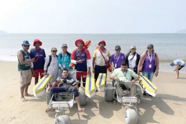 Lifeguards assist differntly-abled persons  to enjoy the sea at Miramar beach