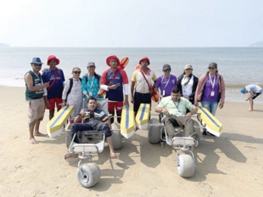 Lifeguards assist differntly-abled persons  to enjoy the sea at Miramar beach