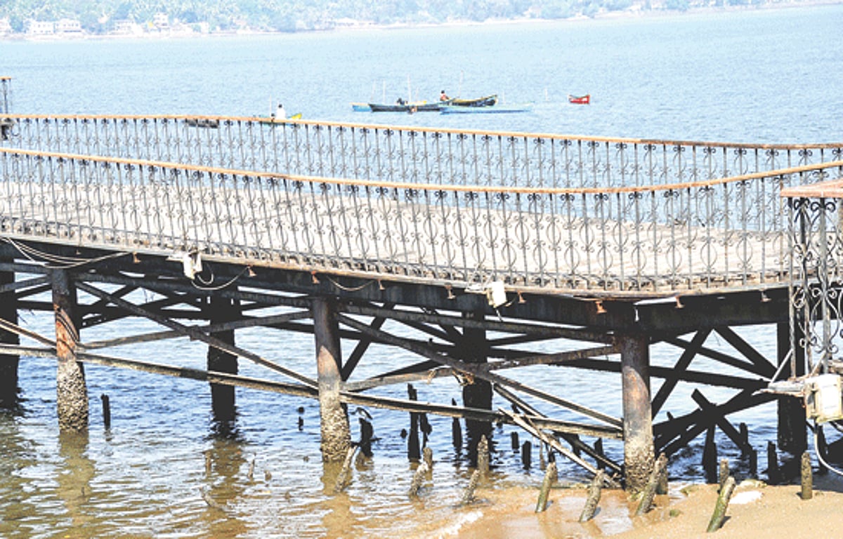 Local fishermen scavenge for shell fish near the dilapidated Kala Academy jetty in Panjim on Friday. The jetty once used by the public is now closed for visitors to avert accidents.