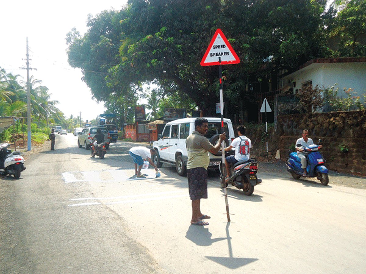 Locals paint a speed breaker at Nagoa on Friday