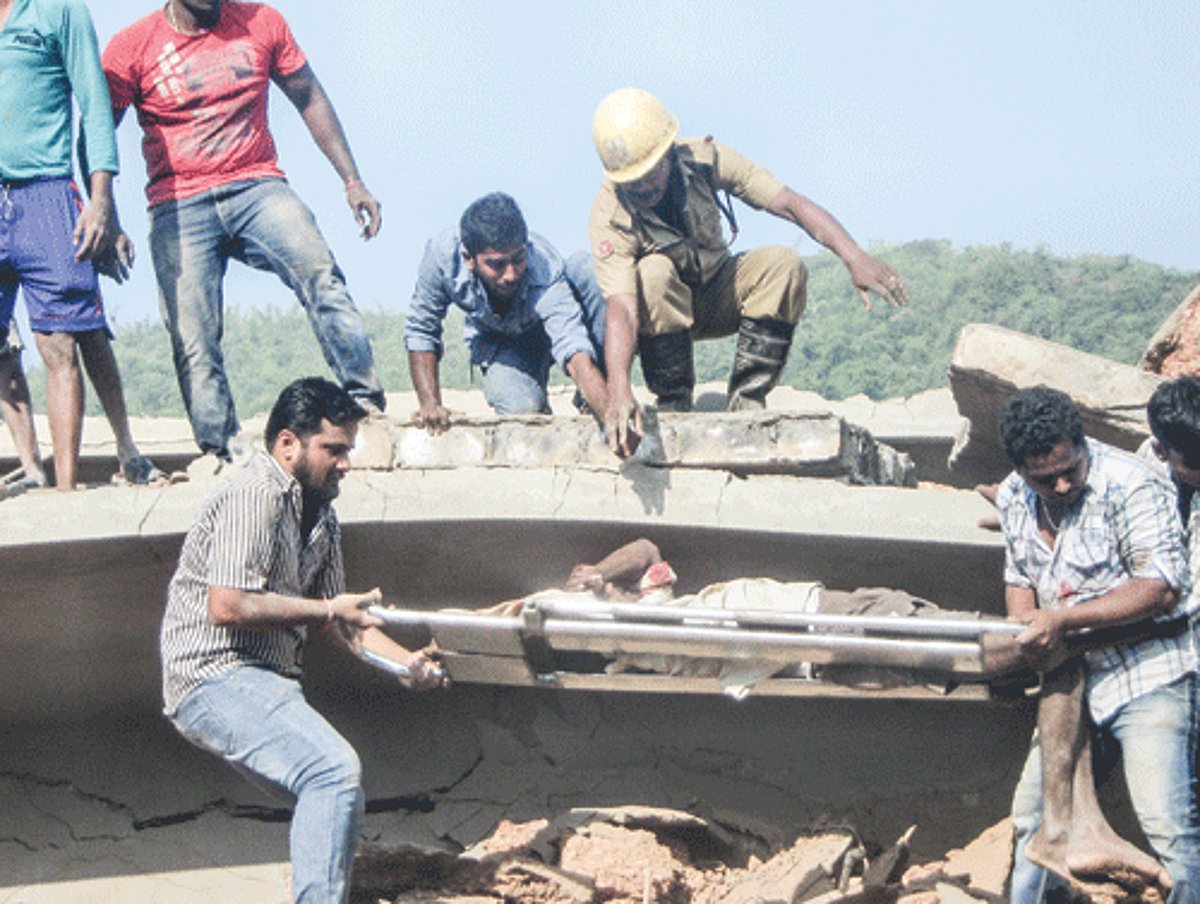 Locals shift a worker for medical care after he was pulled out of the debris.