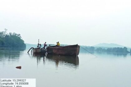 Locals spot men in boat extracting river sand with suction pump at Macazana