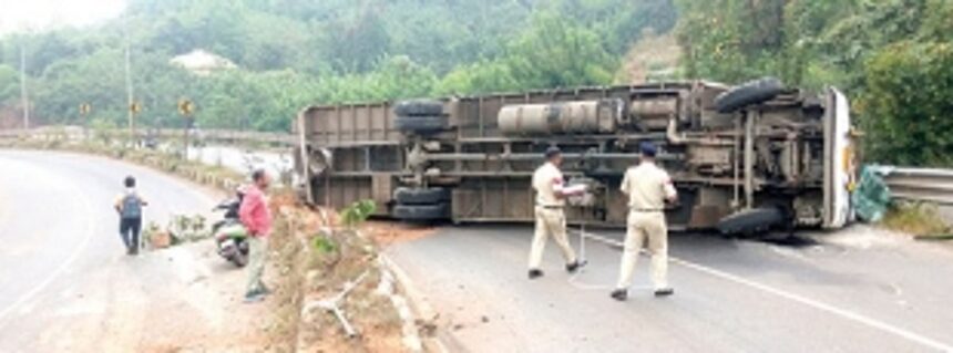 Lucky escape for commuters after truck moves down slope in reverse and falls on its side