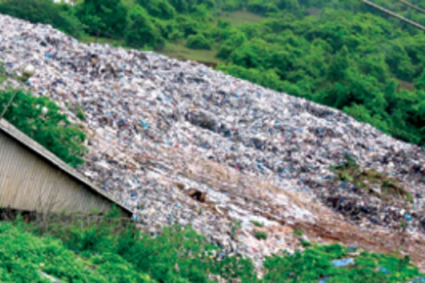 MMC uses machinery to make way for  waste-laden trucks at Sonsoddo