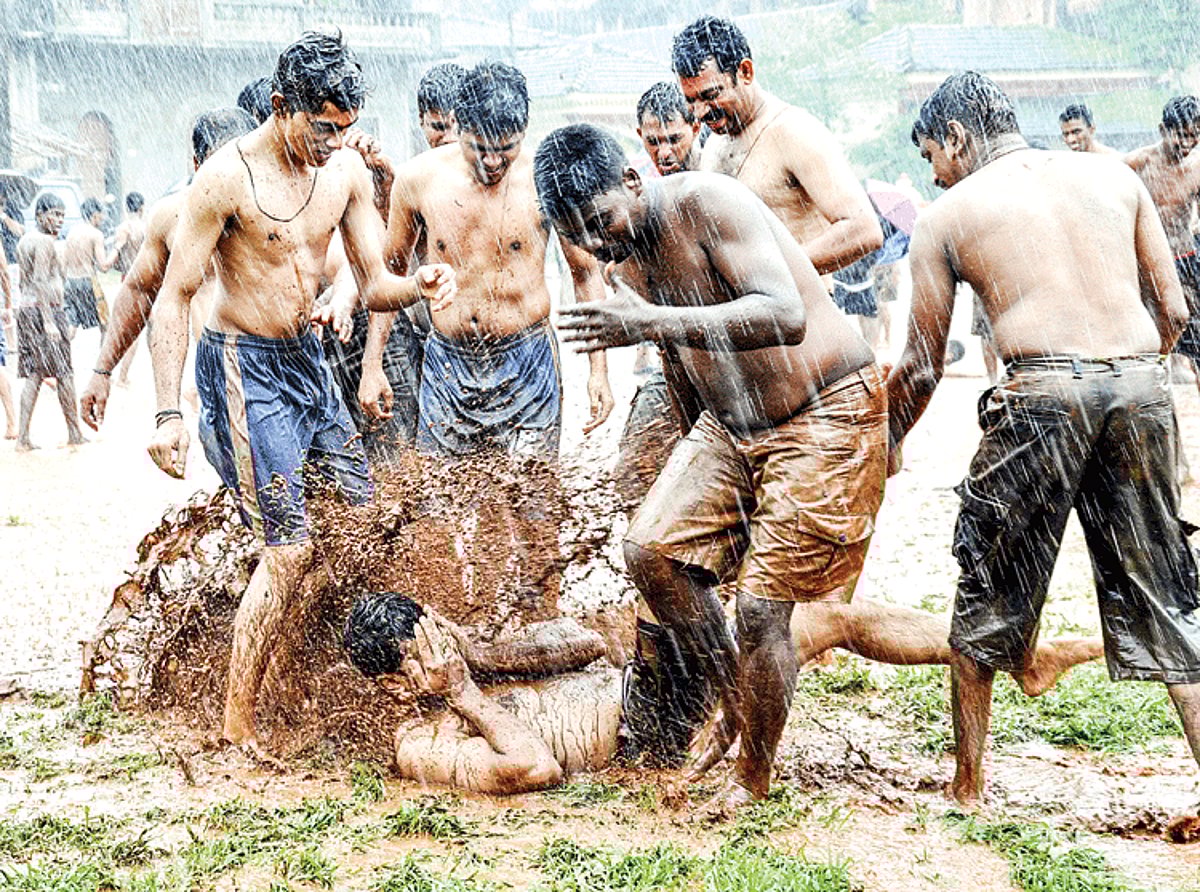 MUD THERAPY:  Youth play traditional games in the muck known as Chikhal Kalo in front of a peepal tree near the Devaki-Krishna temple in Marcela on Saturday