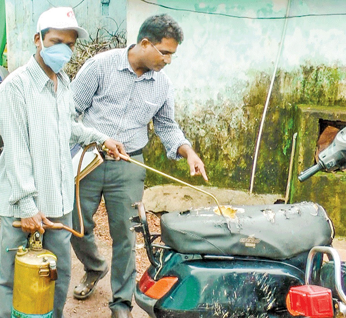 Margao Urban health officials spraying chemicals on a scooter as part of the anti-larvae operations.