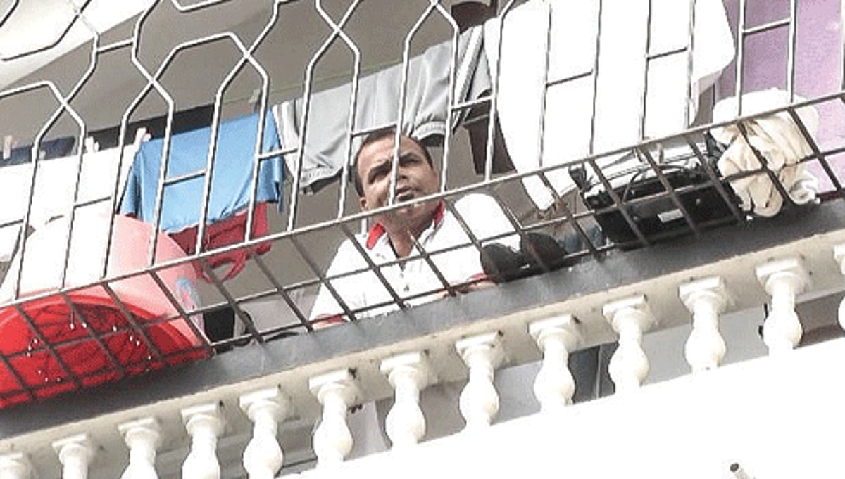 Mickky takes a look from his balcony when the search was going inside his appartment.