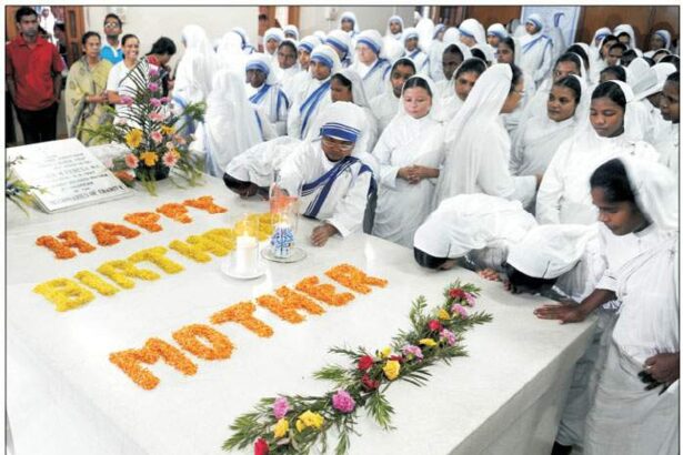 Missionaries of Charity nuns and volunteers kiss Mother Teresa's tomb as they celebrate her 99th birth anniversary at the Missionaries of Charity Mother House in Kolkata on Wednesday.