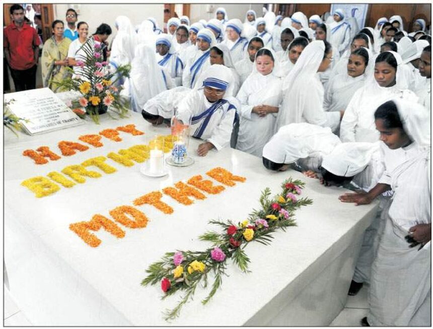 Missionaries of Charity nuns and volunteers kiss Mother Teresa's tomb as they celebrate her 99th birth anniversary at the Missionaries of Charity Mother House in Kolkata on Wednesday.