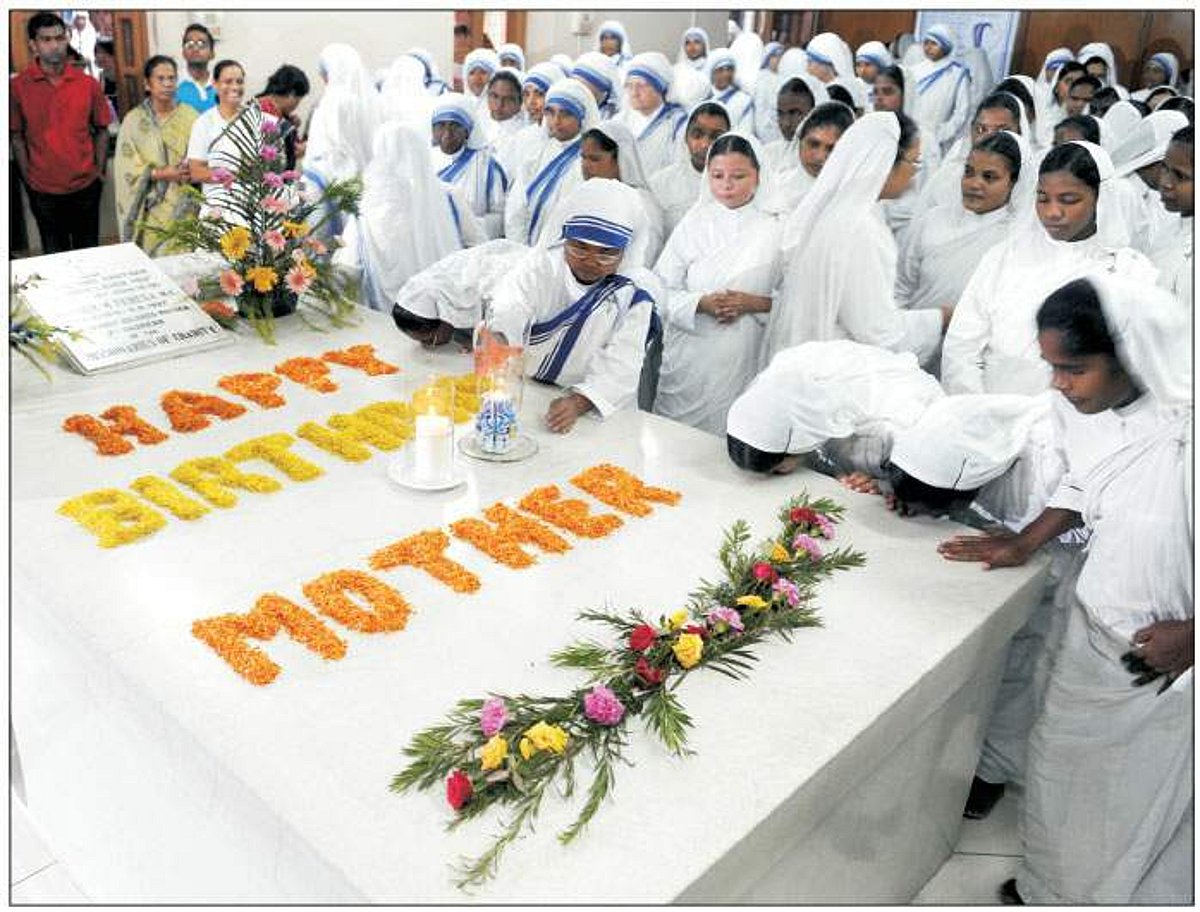 Missionaries of Charity nuns and volunteers kiss Mother Teresa's tomb as they celebrate her 99th birth anniversary at the Missionaries of Charity Mother House in Kolkata on Wednesday.