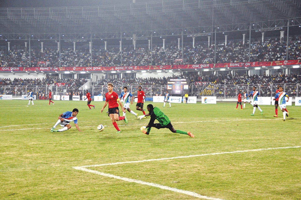 Mozambique goalkeeper Cesar Machava advances to collect the ball from his team captain Edson Almeida as Goa-India player Myron Fernandes moves in to strike. India beat Mozambique 3-2 in the Lusofonia Football finals at Nehru Stadium, Fatorda, on Tuesday.