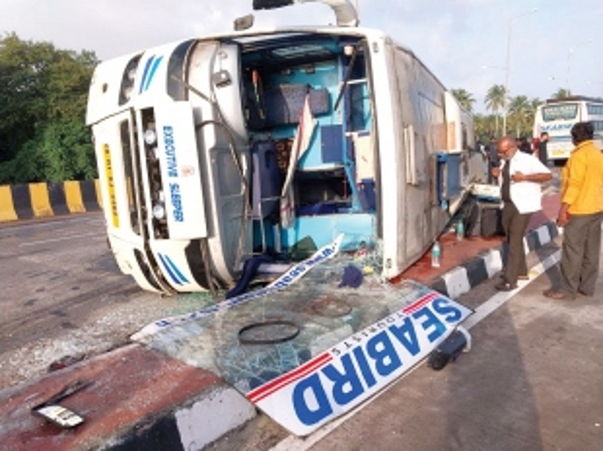 Narrow escape for passengers as  inter-State bus falls on its side at Agasaim