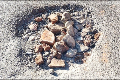 Newly Repaired Road in Sangolda Poses Danger to Motorists Due to Bricks in Inspection Pits