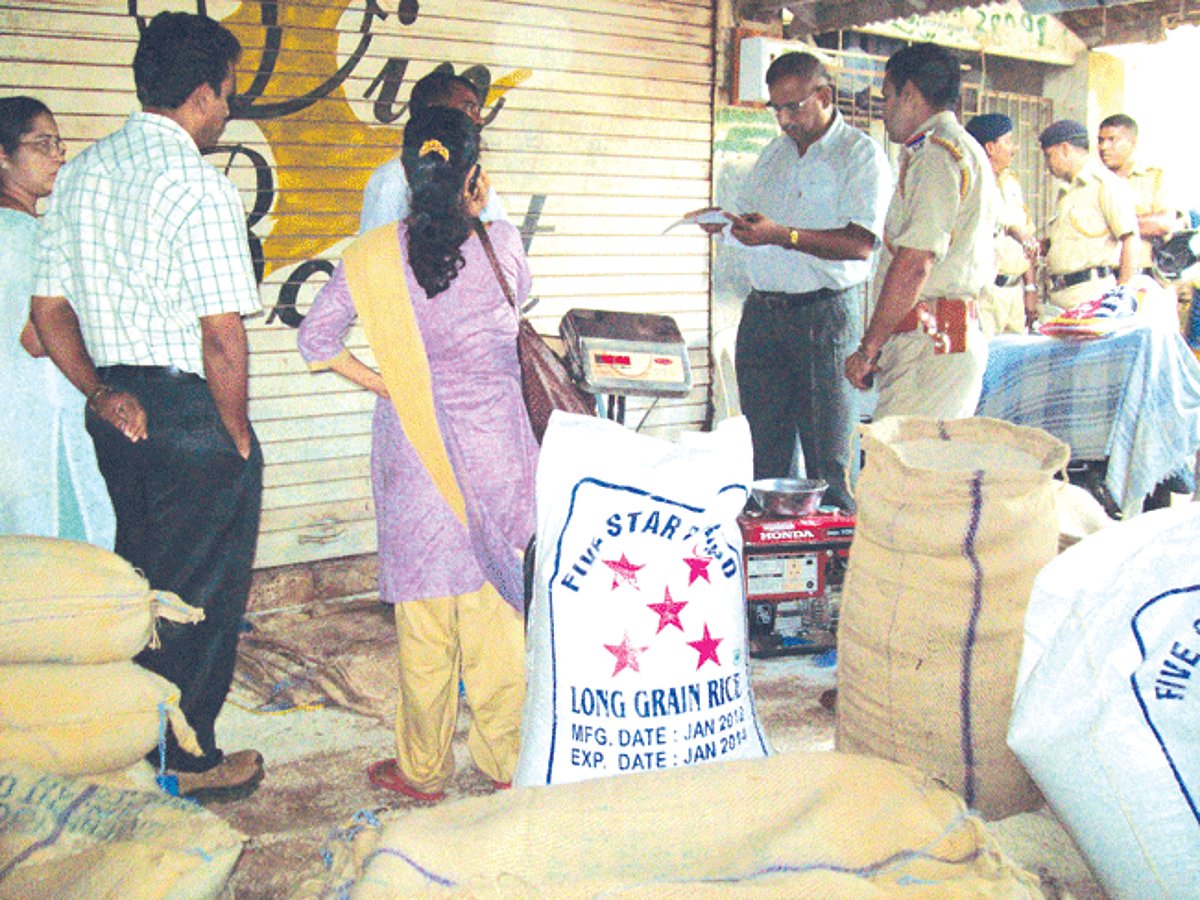POLICE CHECK: Ponda police inspect the rice after busting the black-marketing racket.