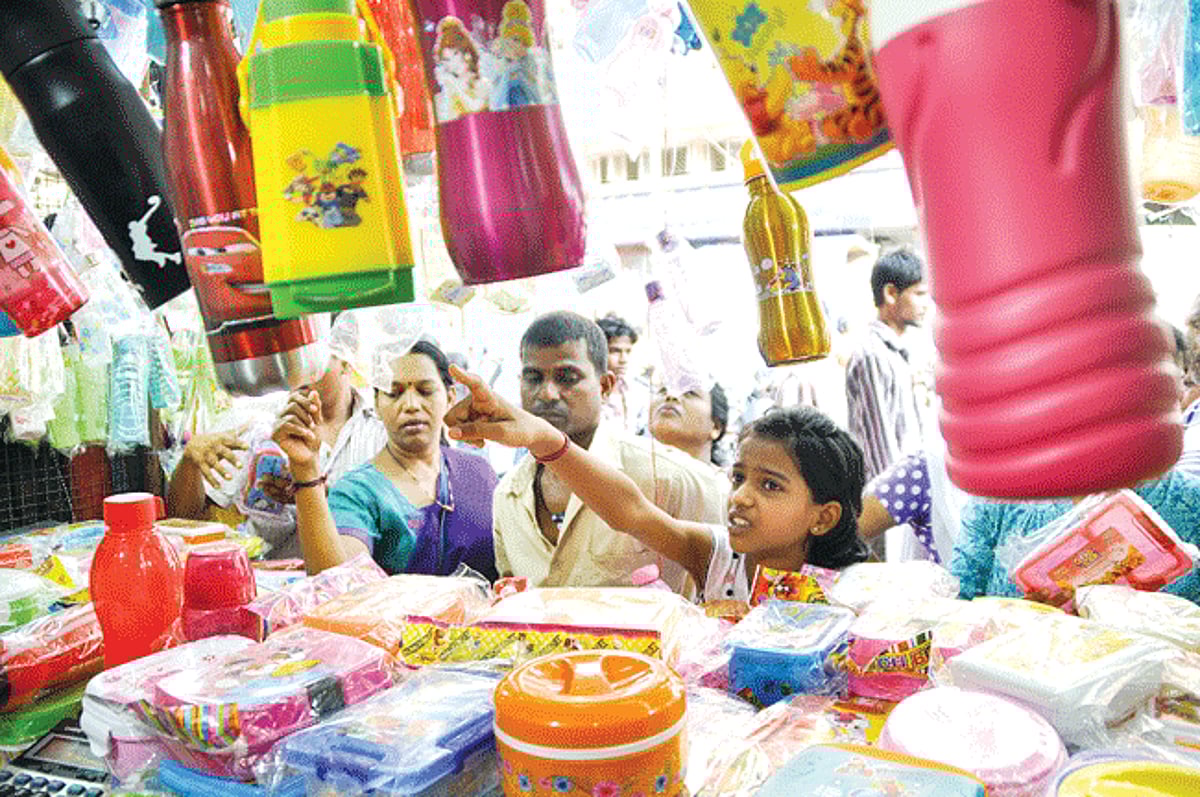 PRE-SCHOOL PREPARATIONS: Parents accompanied by their child shop for water bottles, tiffin boxes and bags before the beginning of the new academic year, at the Panjim market on Monday.