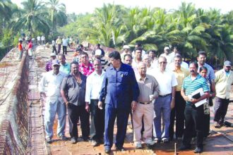 PWD Minister Churchill Alemao inspecting work on the Telaulim-Varca bridge over River Sal.