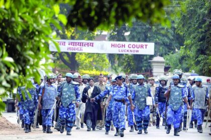 Paramilitary soldiers escort the lawyers of Sunni Waqf Board and All Babri Masjid Action Committee as they leave the HC.