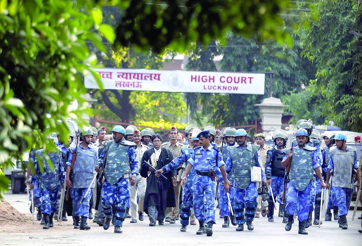 Paramilitary soldiers escort the lawyers of Sunni Waqf Board and All Babri Masjid Action Committee as they leave the HC.