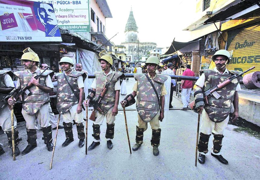 Paramilitary troops stand guard on a street in Ayodhya on Wednesday.